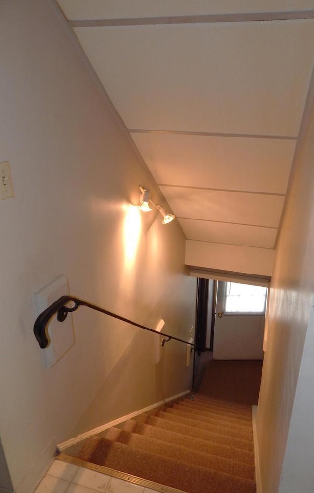 stairs featuring vaulted ceiling