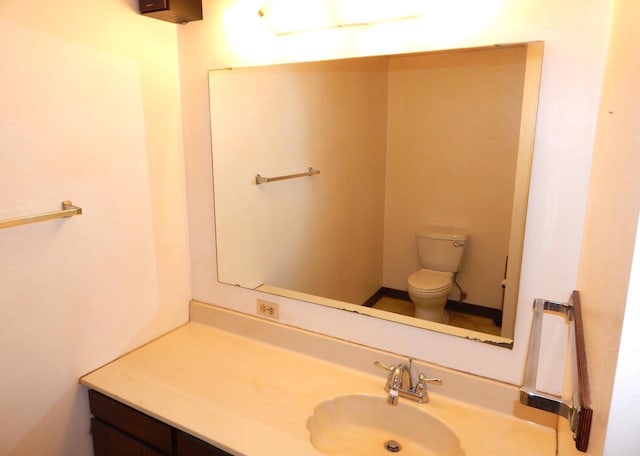 bathroom with toilet and vanity