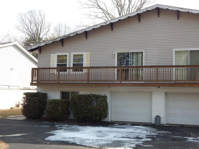 rear view of property featuring a garage