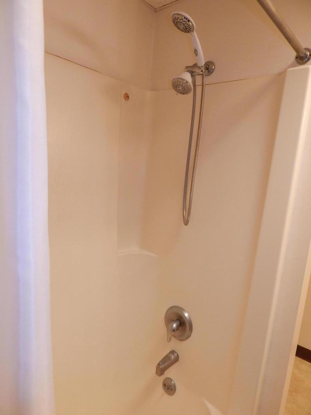 interior details featuring shower / tub combination