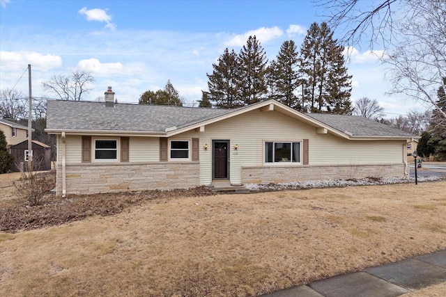 single story home with stone siding, a chimney, and roof with shingles