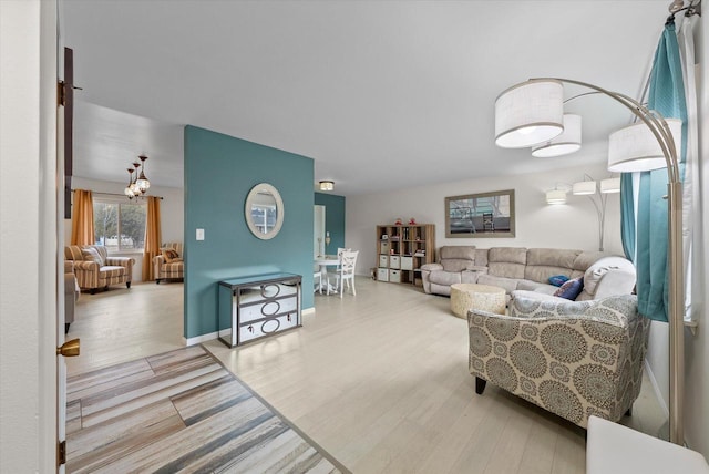 living area with baseboards and wood finished floors