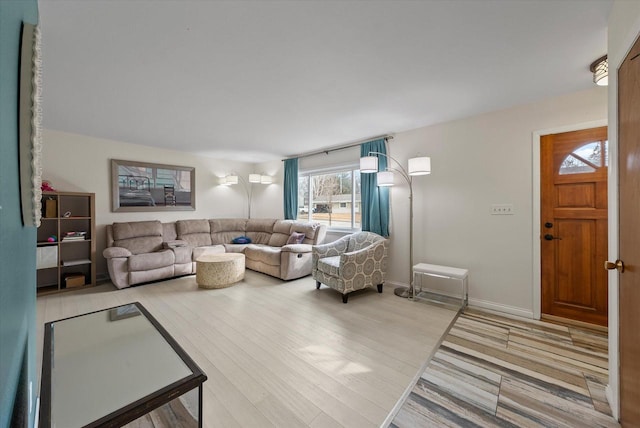 living room featuring baseboards and wood finished floors