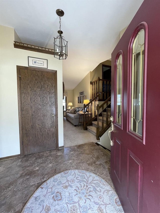 foyer entrance featuring a notable chandelier and stairs