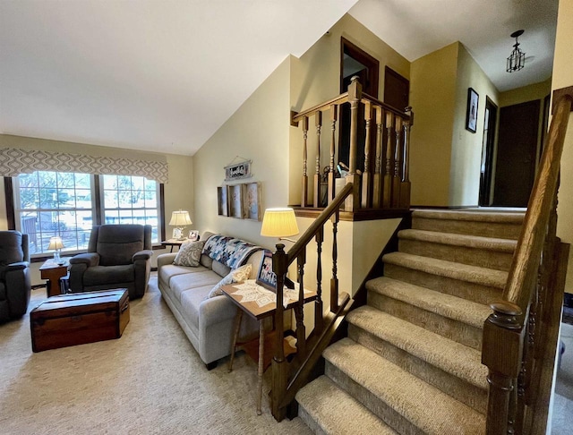 carpeted living room with stairway and lofted ceiling