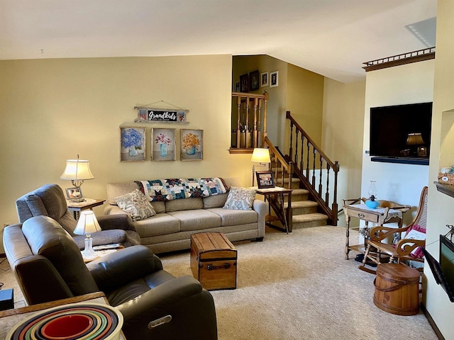 carpeted living room with stairs