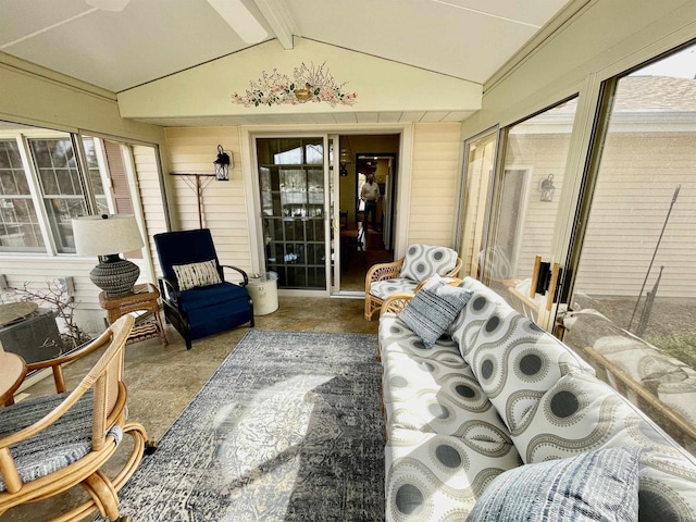 sunroom featuring lofted ceiling with beams