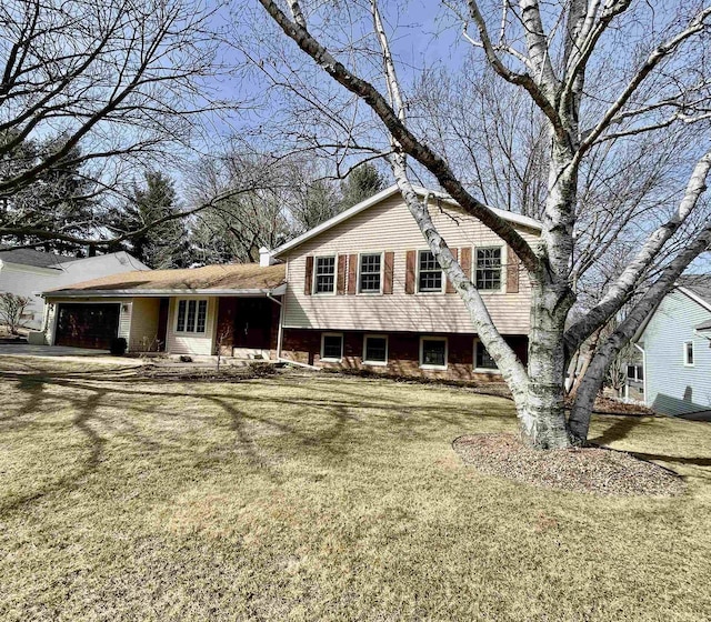 tri-level home with a front yard and an attached garage