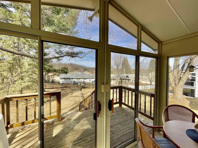 sunroom featuring vaulted ceiling and a wealth of natural light