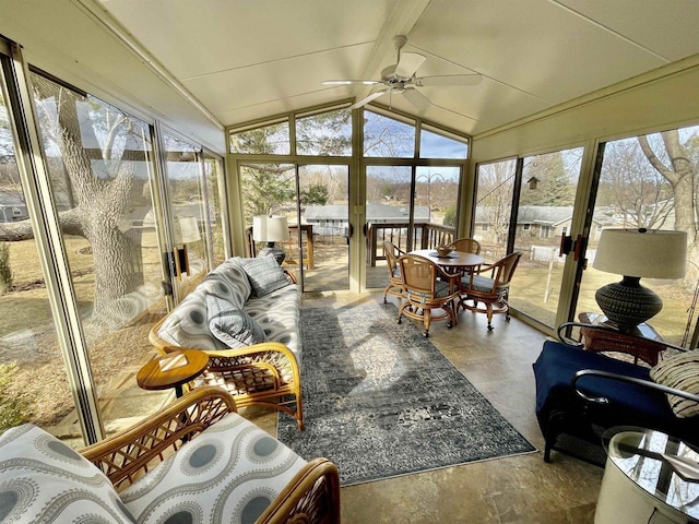 sunroom / solarium featuring ceiling fan and vaulted ceiling with beams