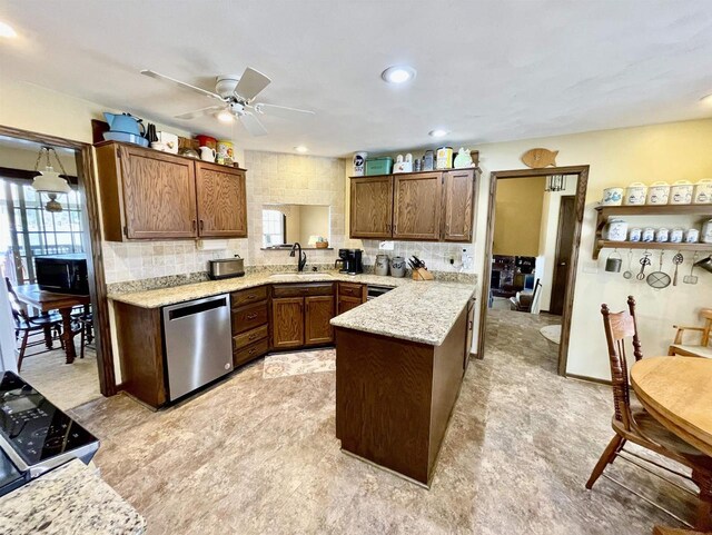 kitchen with dishwasher, a peninsula, stove, and a wealth of natural light