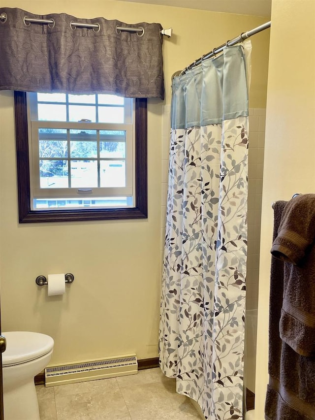 full bath with tile patterned floors, a baseboard heating unit, toilet, and a shower with shower curtain