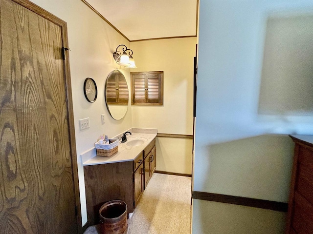 bathroom with vanity, baseboards, and ornamental molding