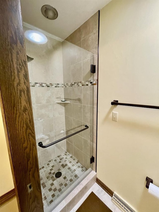 full bath featuring visible vents, a stall shower, and baseboards