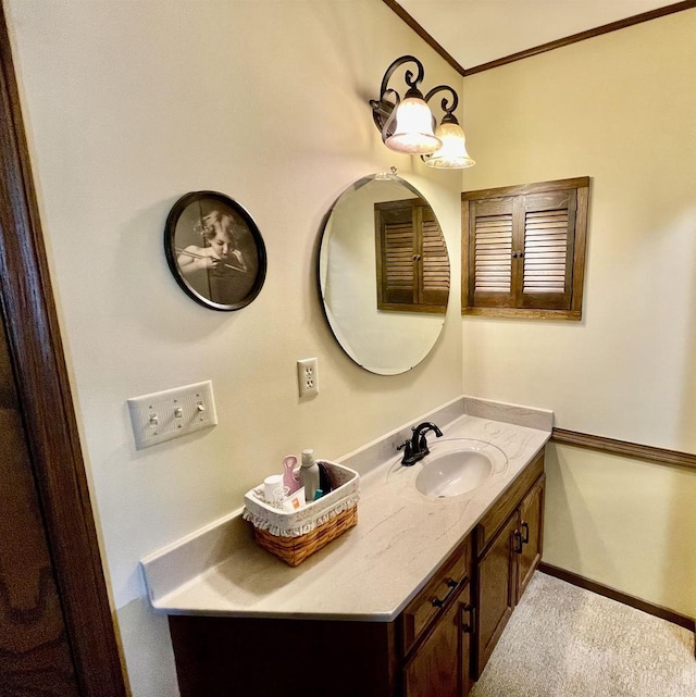 bathroom with baseboards, vanity, and crown molding