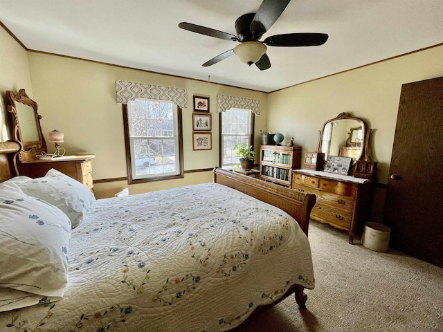 bedroom with a ceiling fan, light colored carpet, and crown molding