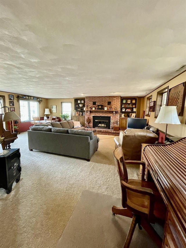 carpeted living room with visible vents and a fireplace