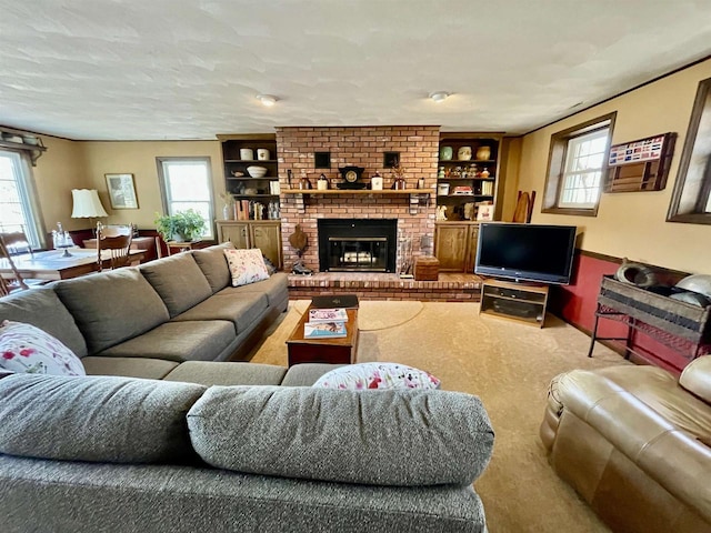 living room featuring a wealth of natural light, a textured ceiling, and a fireplace