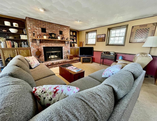 living room with built in features, carpet floors, and a brick fireplace