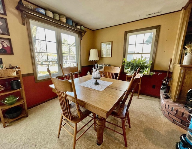 dining area featuring visible vents and light colored carpet