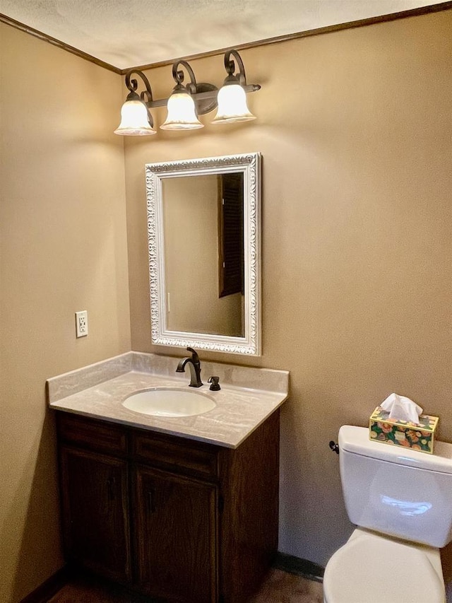 bathroom featuring toilet and vanity