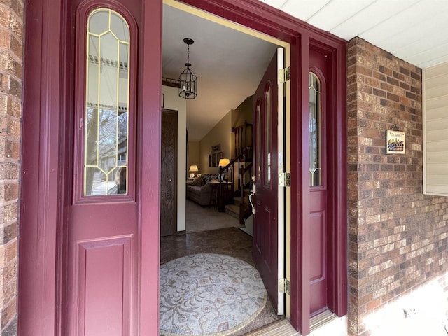 doorway to property featuring brick siding