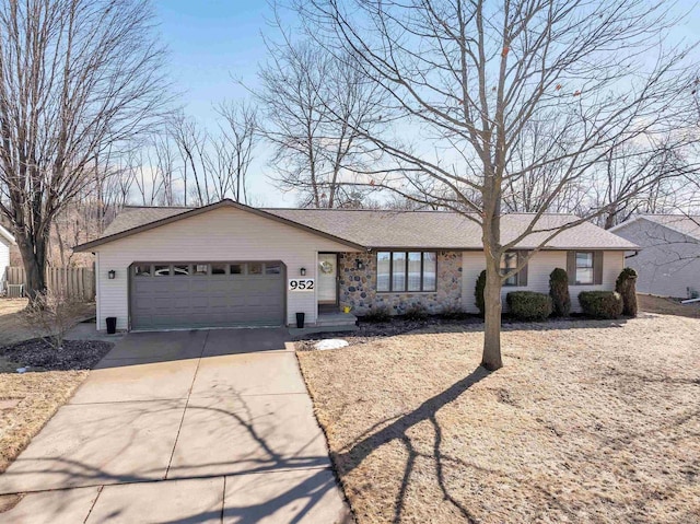 ranch-style house with concrete driveway and an attached garage