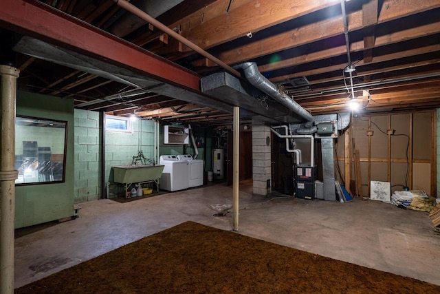 below grade area featuring a sink, heating unit, separate washer and dryer, and electric water heater