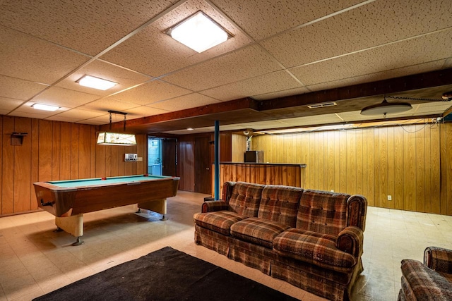 game room featuring tile patterned floors, wooden walls, and billiards