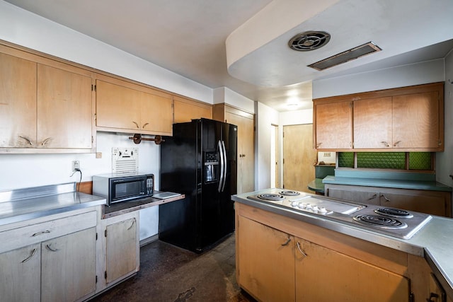 kitchen featuring concrete floors, black appliances, and light countertops