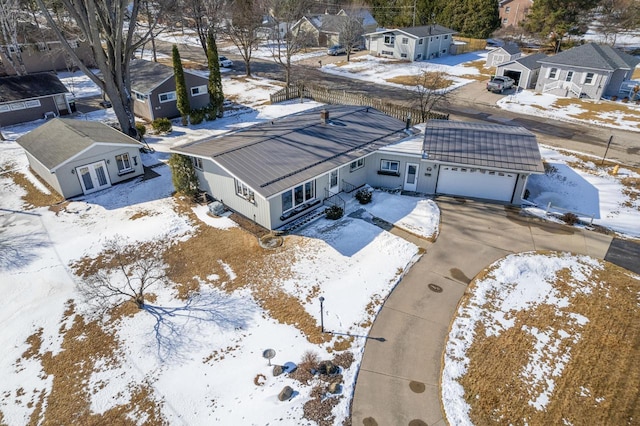 snowy aerial view featuring a residential view