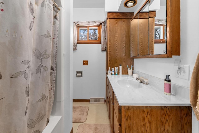 bathroom featuring vanity, baseboards, and visible vents