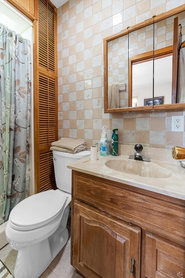 full bathroom featuring vanity, tile walls, toilet, and backsplash