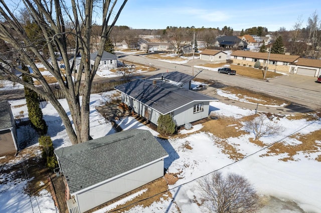 snowy aerial view featuring a residential view