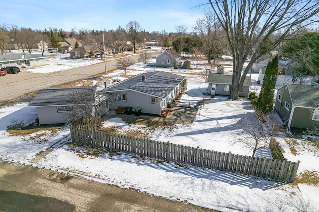 snowy aerial view with a residential view