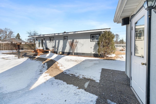 view of front of property with crawl space, fence, and french doors