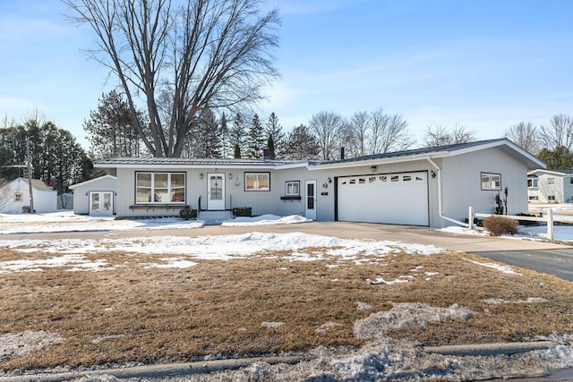 ranch-style home featuring an attached garage, driveway, and french doors