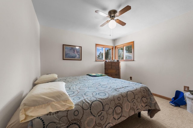 carpeted bedroom featuring a ceiling fan and baseboards