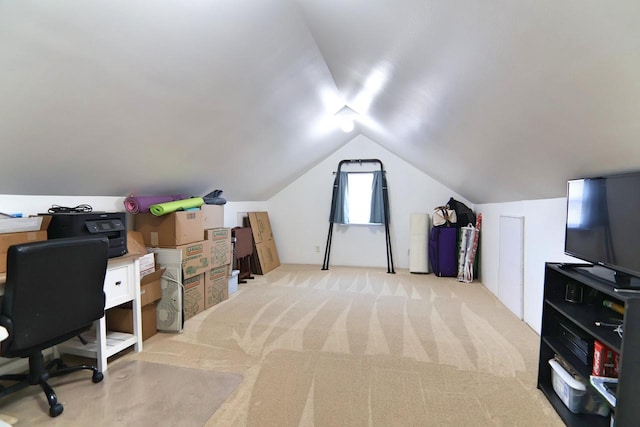 home office featuring light carpet and vaulted ceiling