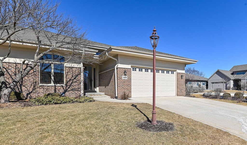 3400 Sequoia Cir, Waukesha, WI 53188 - view of front of property with brick siding, driveway, a front lawn, and a garage