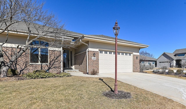 view of front of property with brick siding, driveway, a front lawn, and a garage