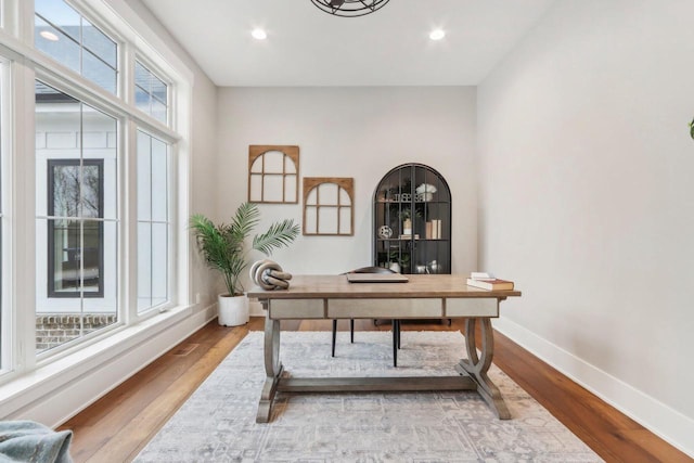 office space featuring light wood-style flooring, recessed lighting, and baseboards