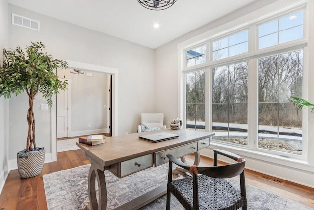 office area with recessed lighting, visible vents, baseboards, and wood finished floors