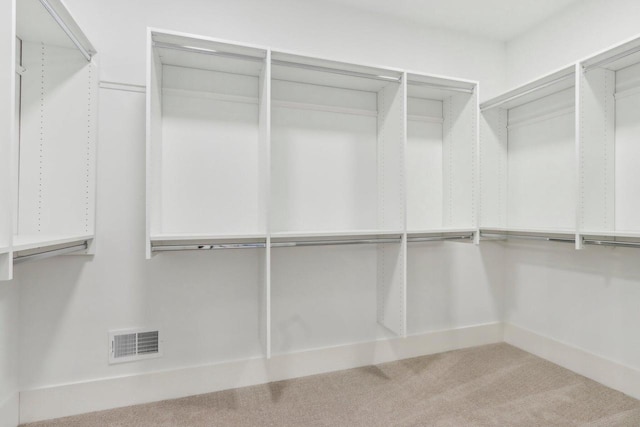 walk in closet featuring visible vents and carpet flooring