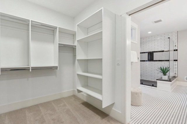 walk in closet with carpet flooring and visible vents