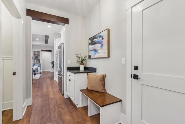 hallway with dark wood finished floors and recessed lighting