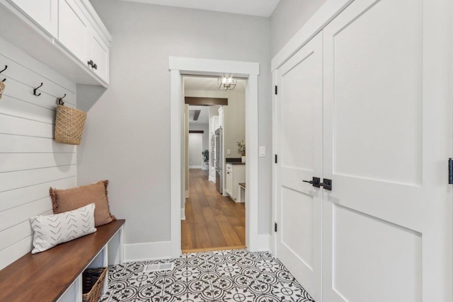 mudroom with light tile patterned floors and baseboards