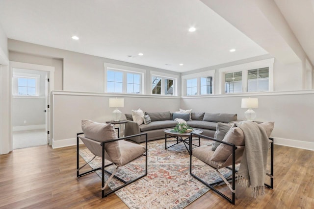 living room with recessed lighting, baseboards, and wood finished floors