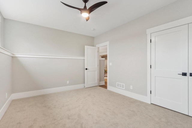 unfurnished bedroom with visible vents, a ceiling fan, baseboards, and carpet floors