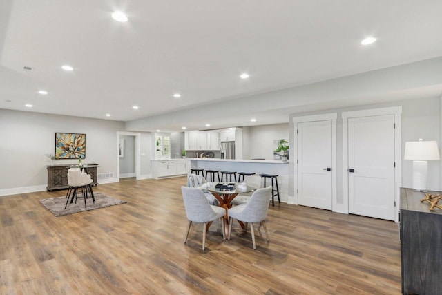 dining room featuring recessed lighting, baseboards, and wood finished floors